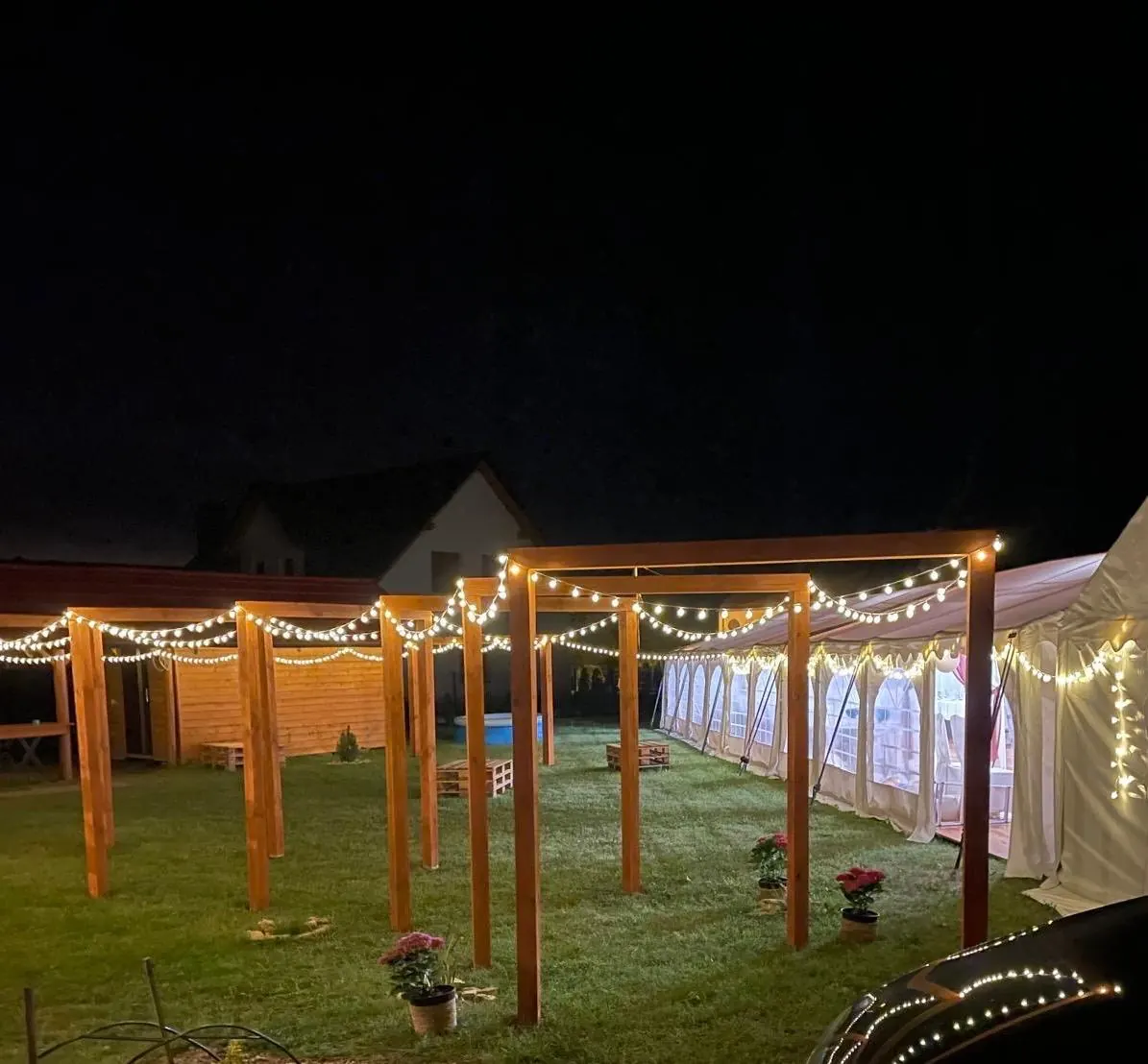 Namiot nocą z girlandami świetlnymi